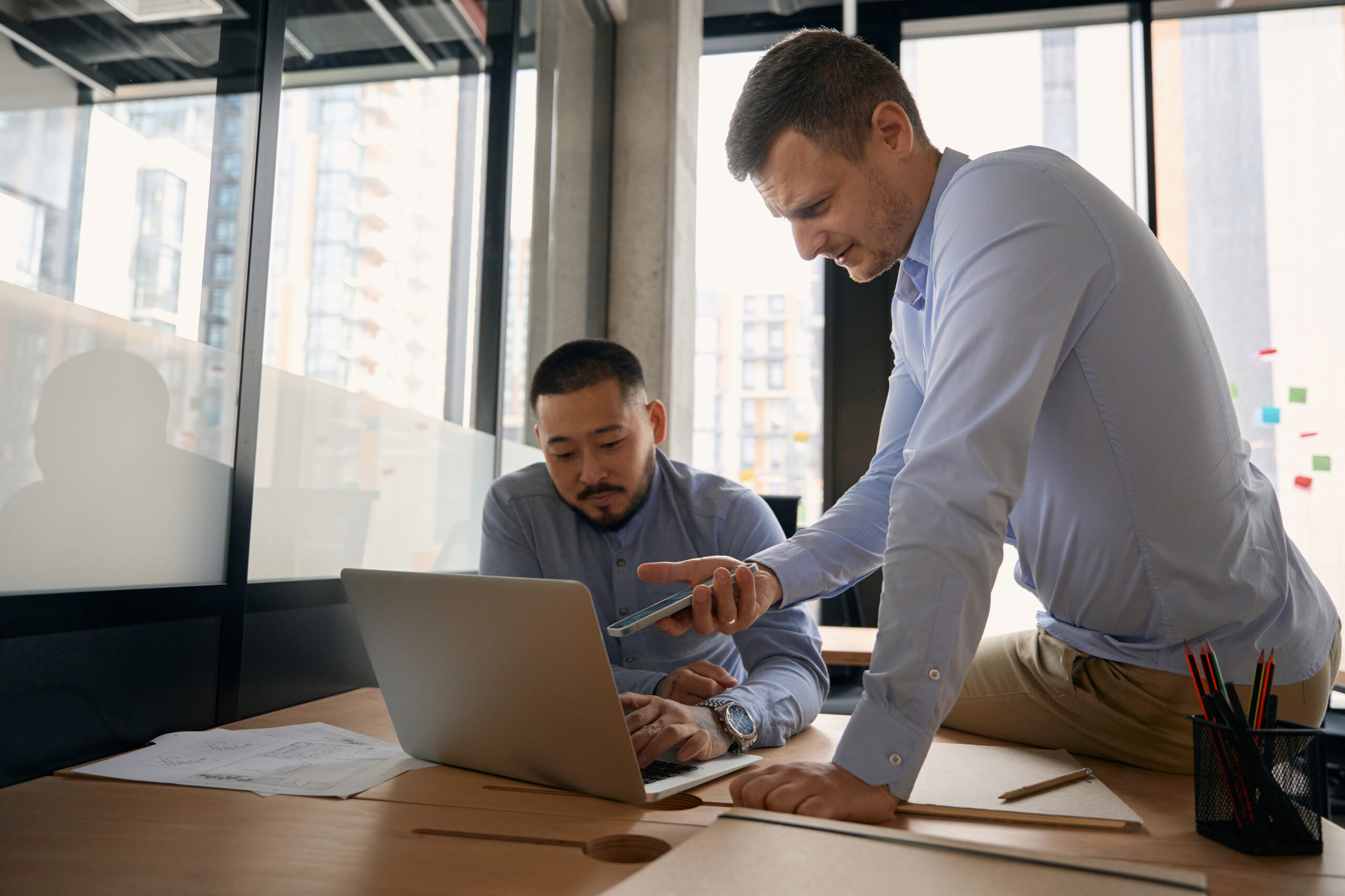 corporate workers sending files from mobile device to computer