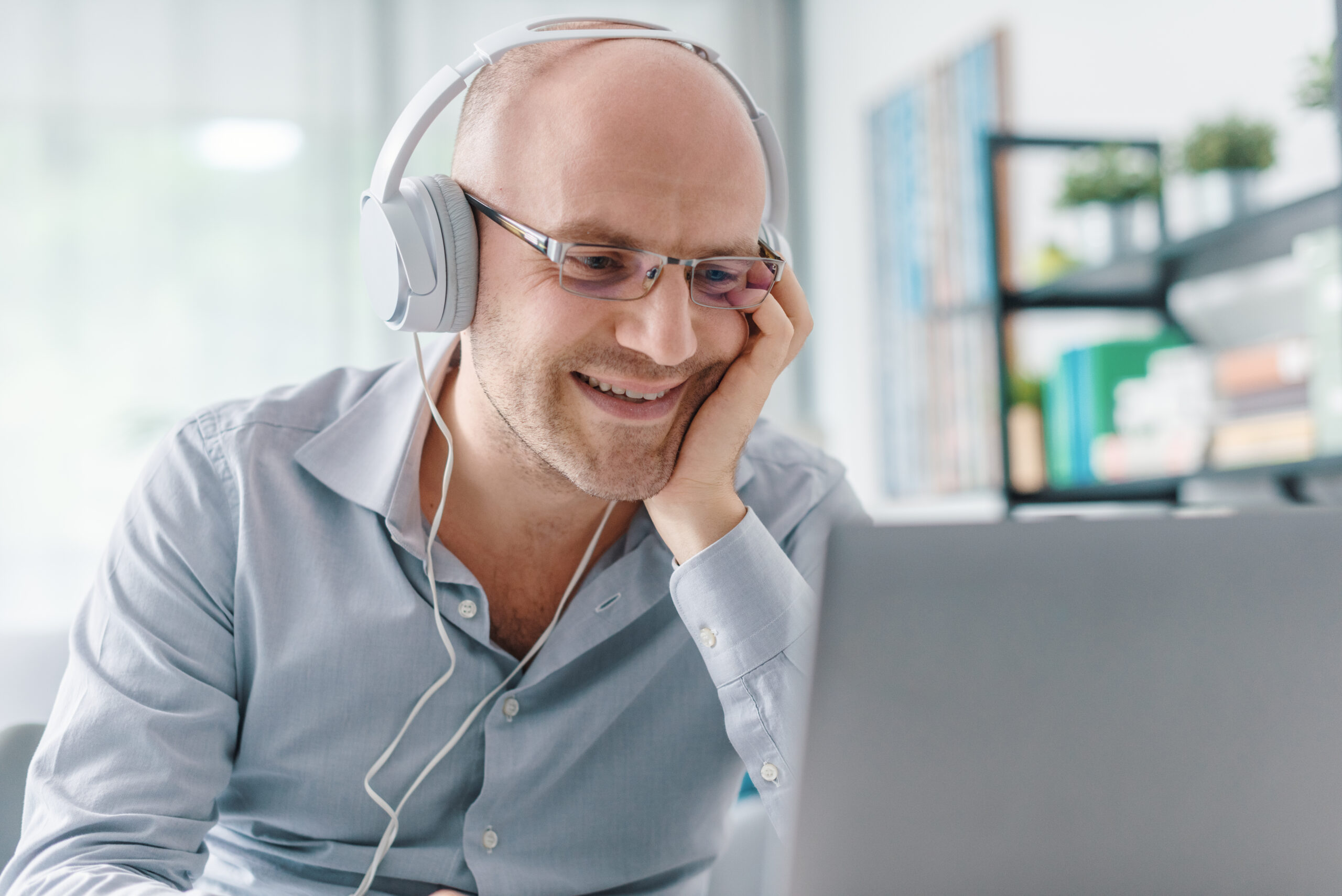 Happy remote worker connecting with his laptop through ucaas