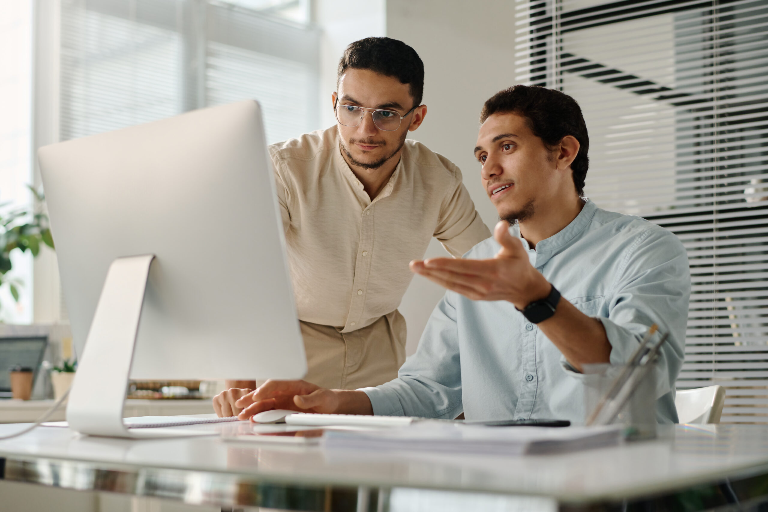 Businessmen discussing online data