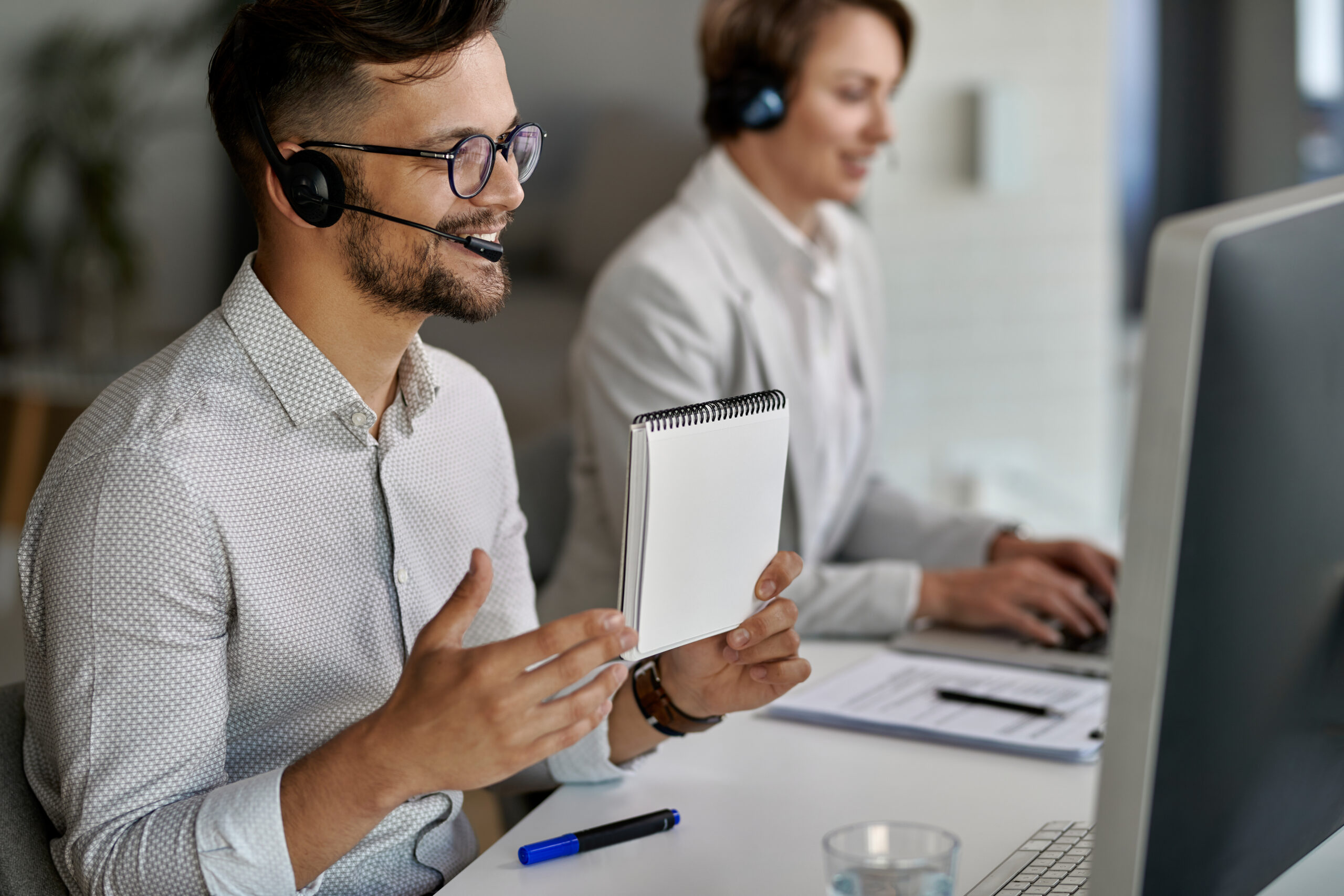 Business team in a modern office using headsets and digital tools during a VoIP migration process.