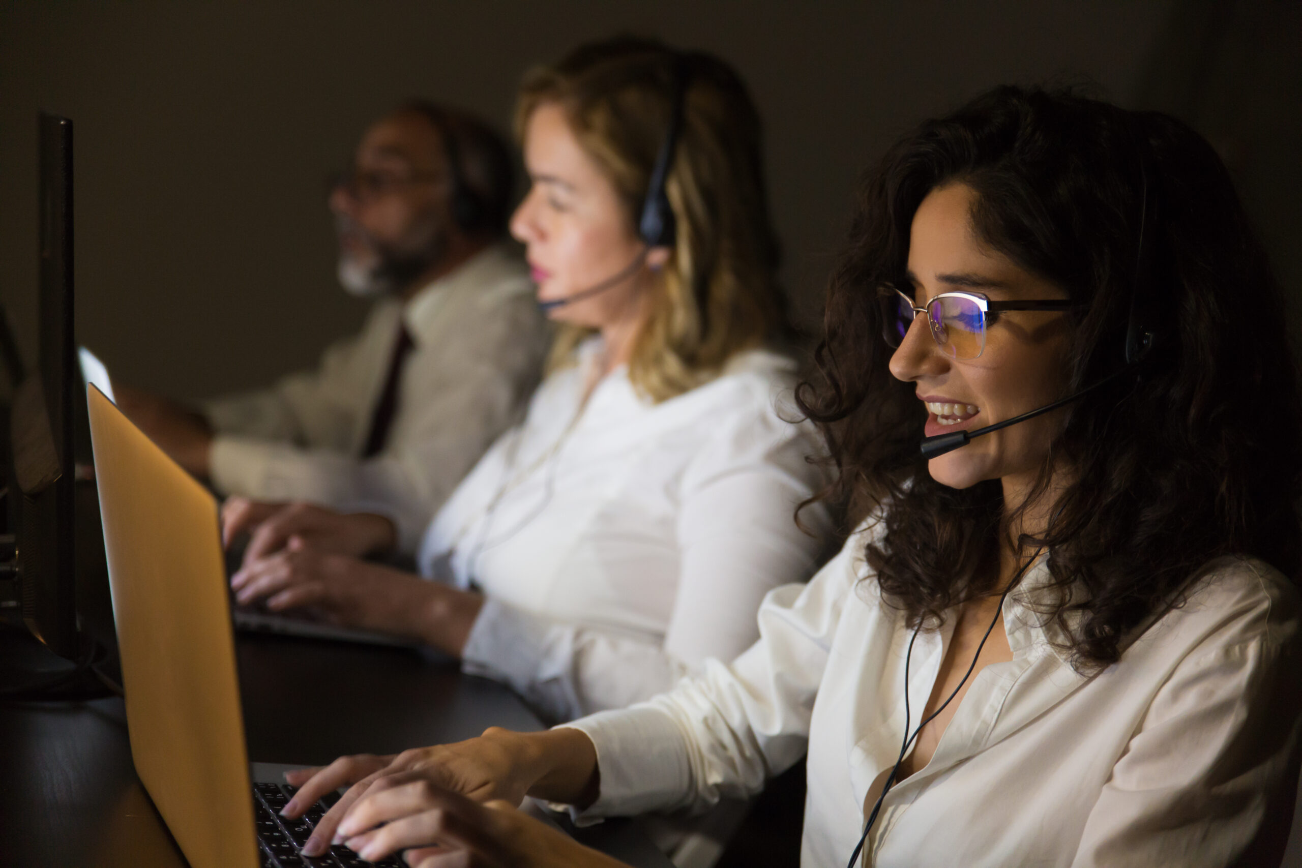 Customer support team using UCaaS tools and headsets to streamline business communication and improve service efficiency
