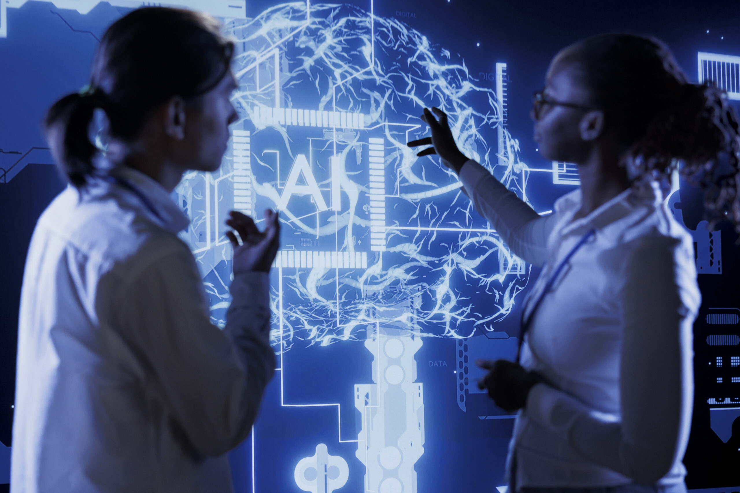 Two professionals analyze a glowing AI brain interface on a digital screen, symbolizing how artificial intelligence is transforming Unified Communications in modern business environments.